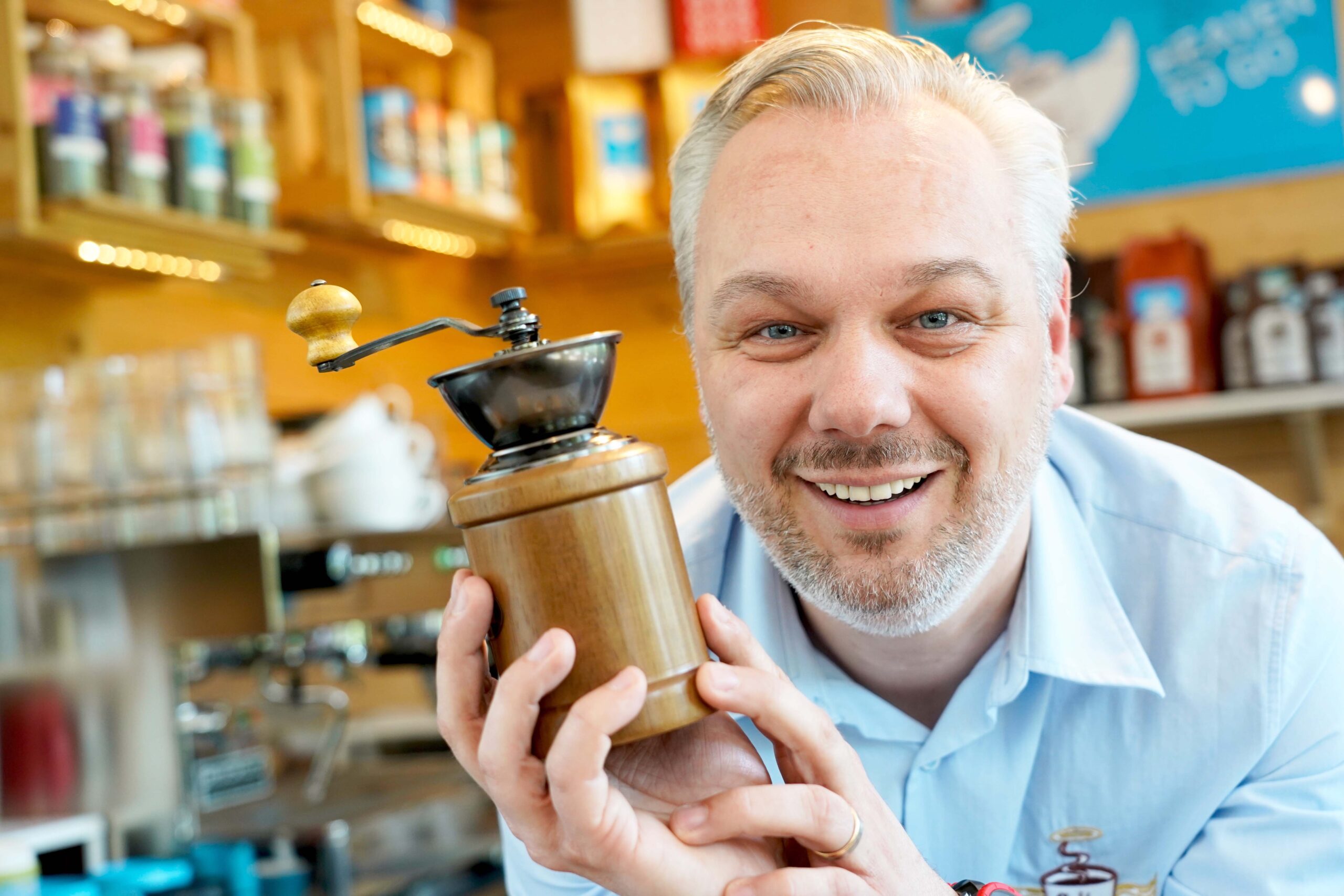 man with coffee grinder
